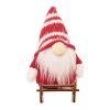 Lutin sur un traîneau en bois rouge
